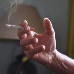 A Cigarette being smoked in the house, leaving a lingering odour.